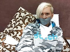 Tied up young guy with a gag.  Suffering from tickling.