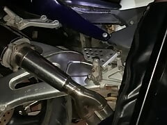 Crossdresser in high heels boots fucking large dildo on motorbike