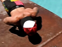Sporty jock relaxes by the pool and strokes his shaft